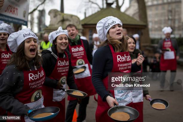 The journailist team cheers their last racer home during the annual Parliamentary Pancake Race in Victoria Tower Gardens on Shrove Tuesday on...