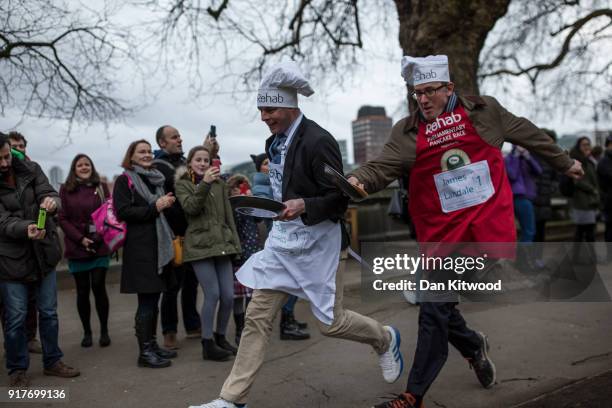The BBC's Diplomatic correspondent James Landale and MP Matt Warman take the first corner in the annual Parliamentary Pancake Race in Victoria Tower...