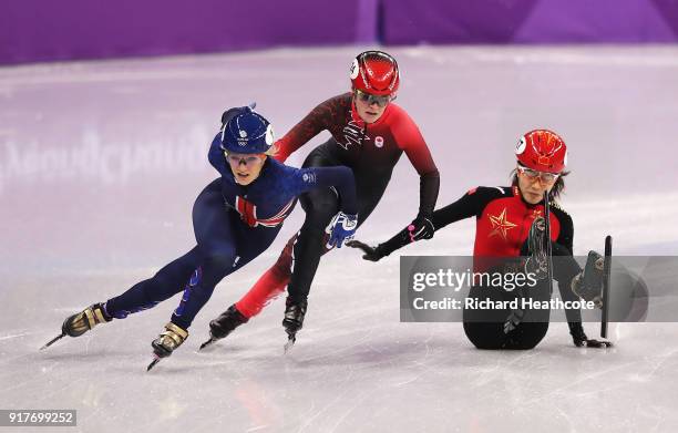 Elise Christie of Great Britain and Kim Boutin of Canada get past a falling Chunyu Qu of China during the Ladies' 500m Short Track Speed Skating...