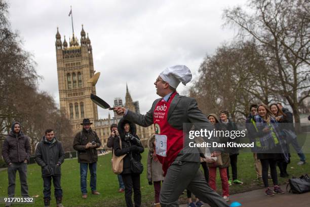 Competitor from the journalist team runs a lap during the annual Parliamentary Pancake Race in Victoria Tower Gardens on Shrove Tuesday on February...