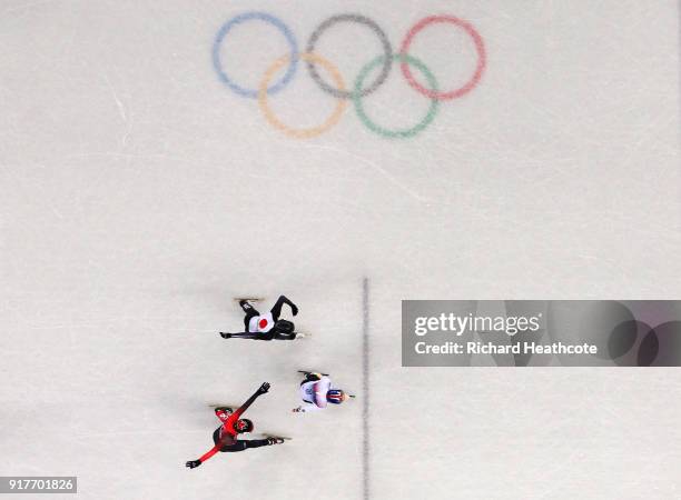 Hyojun Lim of Korea, Kazuki Yoshinaga of Japan and Charle Cournoyer of Canada race towards the finish line during the Men's 1000m Short Track Speed...