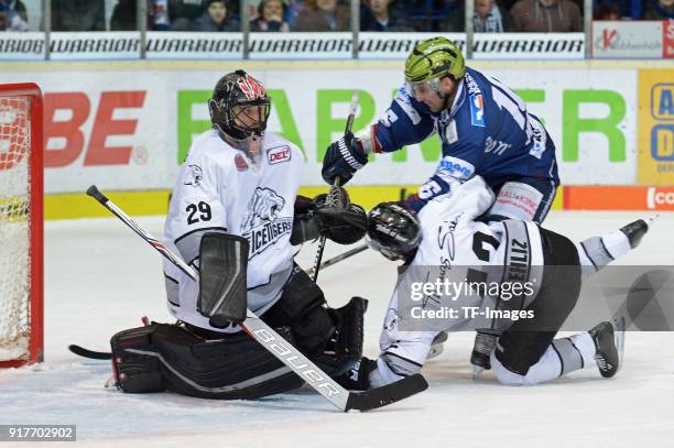 Goalkeeper Andreas Jenike of Nuernberg, Yasin Ehliz of Nuernberg and Jason Jaspers of Iserlohn battle for the ball during the DEL match between...