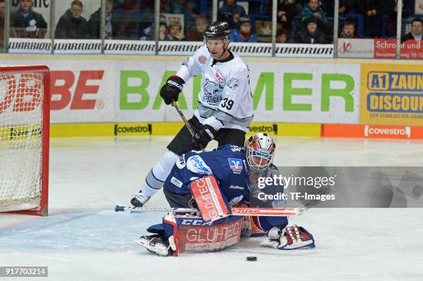 Goalkeeper Sebastian Dahm of Iserlohn and David Steckel of Nuernberg battle for the ball during the DEL match between Iserlohn Roosters and Thomas...