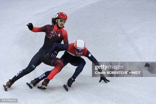 Canada's Samuel Girard falls and Netherlands' Sjinkie Knegt compete in the men's 5,000m relay short track speed skating heat event during the...