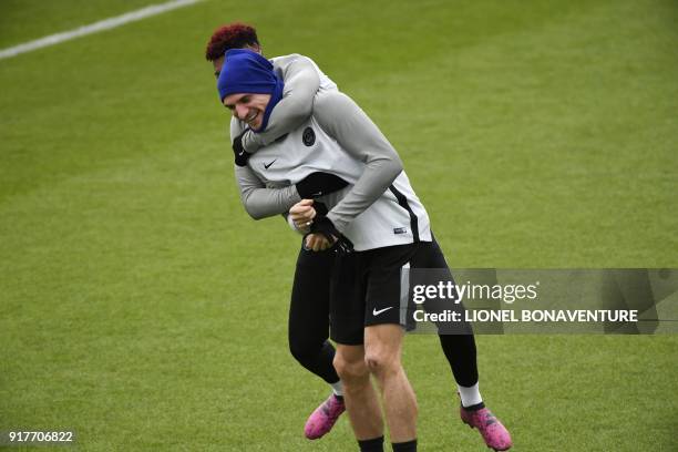 Paris Saint-Germain's French defender Presnel Kimpembe jokes with Paris Saint-Germain's Belgian defender Thomas Meunier during a training session at...