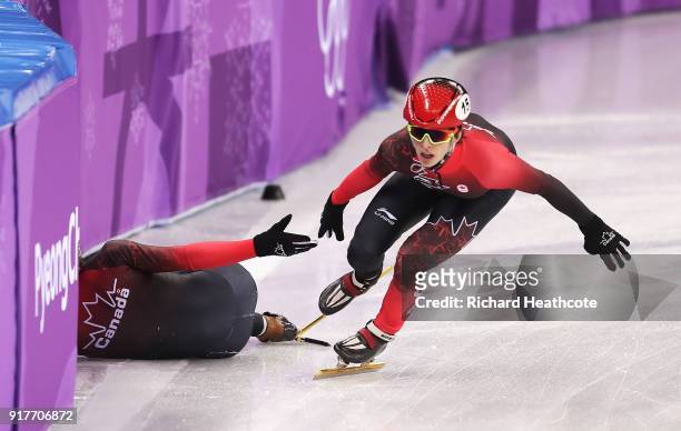 Charle Cournoyer of Canada continues after teammate Samuel Girard of Canada crashes during the Men's 5000m Relay Short Track Speed Skating heat 1 on...