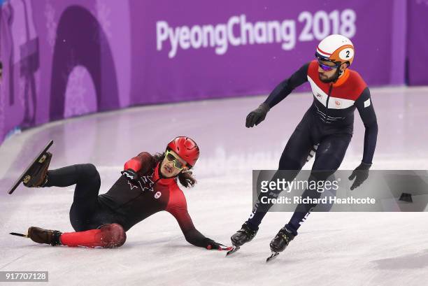 Samuel Girard of Canada crashes near Sjinkie Knegt of the Netherlands during the Men's 5000m Relay Short Track Speed Skating heat 1 on day four of...