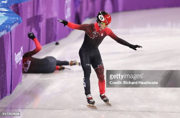 Charle Cournoyer of Canada continues after teammate Samuel Girard of Canada crashes during the Men's 5000m Relay Short Track Speed Skating heat 1 on...