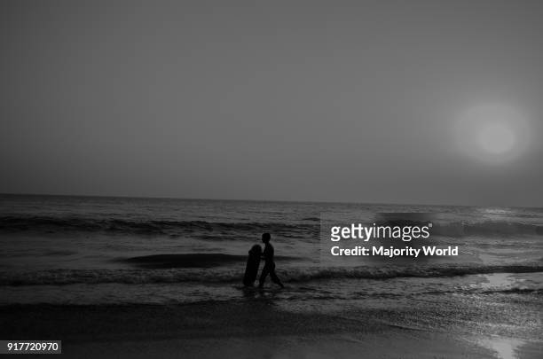 Childhood. A boy walking in the sea at coxs bazar in Bangladesh.