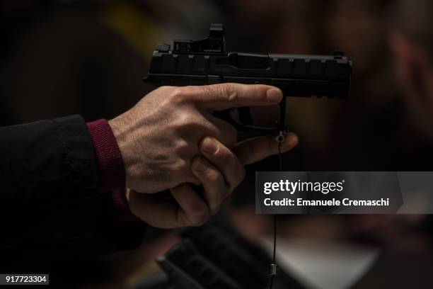 Man holds a dynamic shooting pistol, manufactured by Beretta, during the HIT SHOW exhibition on February 12, 2018 in Vicenza, Italy. HIT SHOW is the...