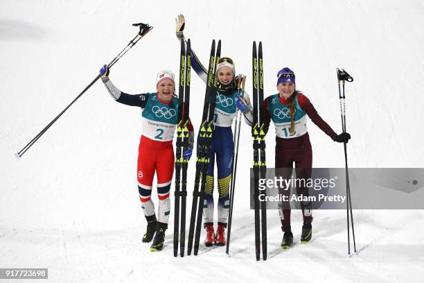 Silver medalist Maiken Caspersen Falla of Norway, gold medalist Stina Nilsson of Sweden and Yulia Belorukova of Olympic Athlete from Russia celebrate...