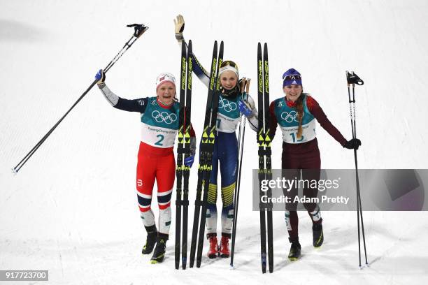 Silver medalist Maiken Caspersen Falla of Norway, gold medalist Stina Nilsson of Sweden and Yulia Belorukova of Olympic Athlete from Russia celebrate...