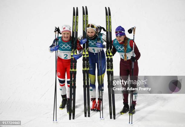 Silver medalist Maiken Caspersen Falla of Norway, gold medalist Stina Nilsson of Sweden and Yulia Belorukova of Olympic Athlete from Russia celebrate...
