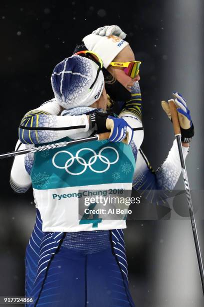 Gold medalist Stina Nilsson of Sweden celebrates with Hanna Falk of Sweden during the Cross-Country Ladies' Sprint Classic Final on day four of the...
