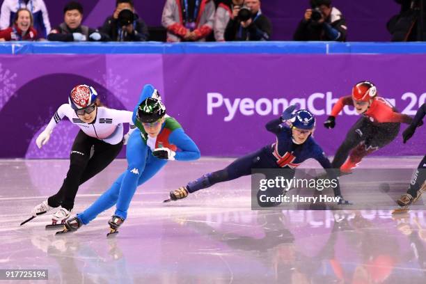 Arianna Fontana of Italy and Minjeong Choi of Korea race past as Elise Christie of Great Britain falls during the Ladies' 500m Short Track Speed...