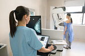 Unrecognizable nurse taking a mammogram exam to an adult patient