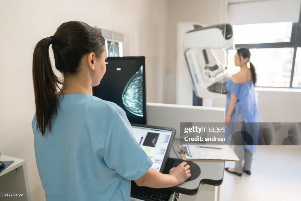 Unrecognizable nurse taking a mammogram exam to an adult patient