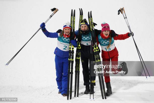 Silver medalist Maiken Caspersen Falla of Norway, gold medalist Stina Nilsson of Sweden and Yulia Belorukova of Olympic Athlete from Russia celebrate...