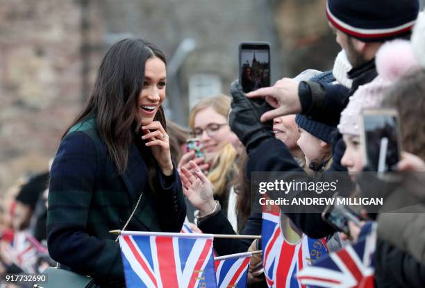 Britain's Prince Harry's fiancée US actress Meghan Markle meets members of the public during a walkabout on the Esplanade at Edinburgh Castle, during...