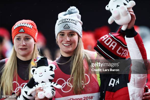 Silver medalist Dajana Eitberger of Germany, gold medalist Natalie Geisenberger of Germany and bronze medalist Alex Gough of Canada celebrate...