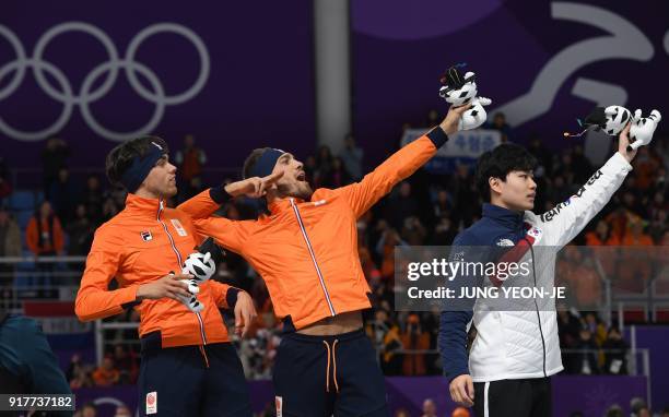 Netherlands' Kjeld Nuis for gold, Netherlands' Patrick Roest for silver and South Korea's Kim Min Seok for bronze celebrate on the podium following...