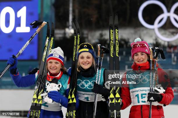Silver medalist Maiken Caspersen Falla of Norway, gold medalist Stina Nilsson of Sweden and bronze medalist Yulia Belorukova of Olympic Athlete from...