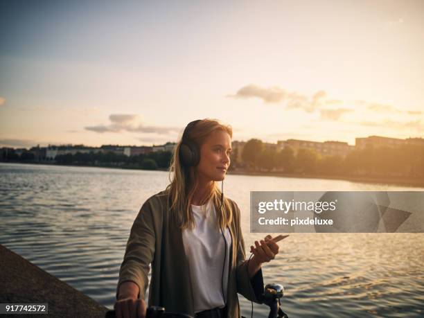 music and this scenery is all she needs - woman listening to music imagens e fotografias de stock