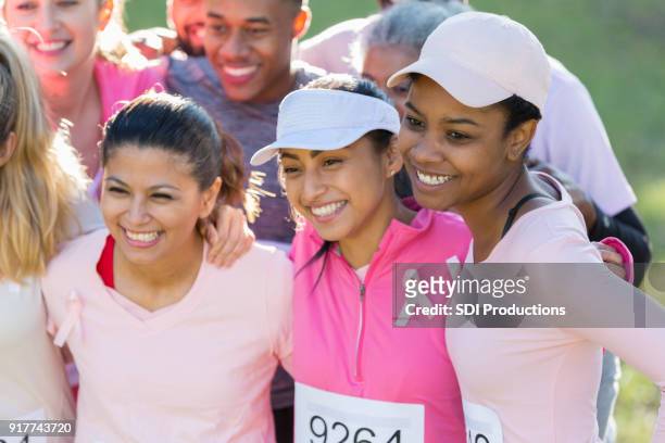 group photo of excited race for the cure participants - sun visor stock pictures, royalty-free photos & images