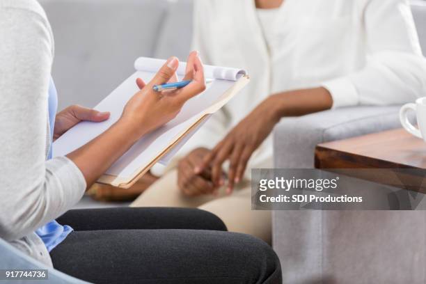 female mental health professional talks with patient - mental health professional stock pictures, royalty-free photos & images