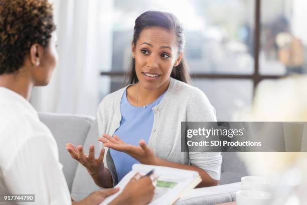 woman gestures while talking with mental health professional - translation stock pictures, royalty-free photos & images