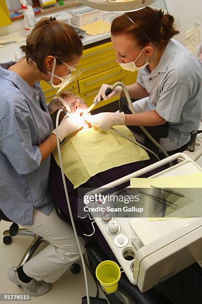 Dentist and her assistant prepare to clean a patient's teeth in this photo illustration at a dentist's office on October 12, 2009 in Berlin, Germany....