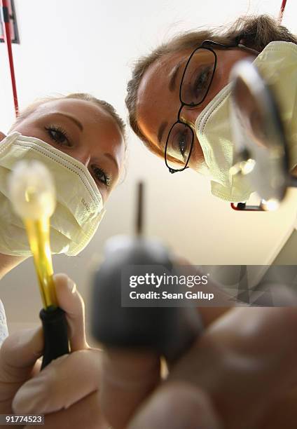 Dentist and her assistant prepare to clean a patient's teeth in this photo illustration at a dentist's office on October 12, 2009 in Berlin, Germany....