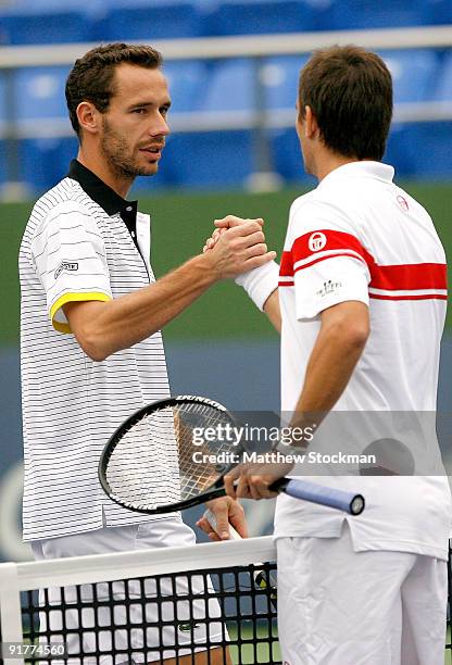 Michael Llodra of France congratulates Tommy Robredo of Spain after their match during day two of the 2009 Shanghai ATP Masters 1000 at Qi Zhong...