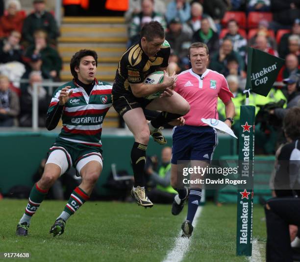 Shane Williams of the Ospreys catches the ball as Lucas Amorosino looks on during the Heineken Cup match between Leicester Tigers and Ospreys at...