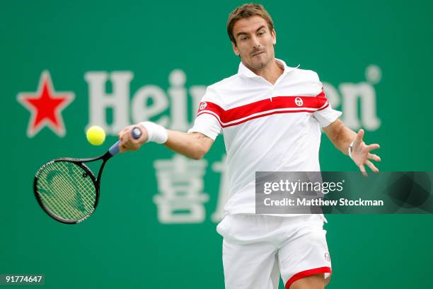 Tommy Robredo of Spain returns a shot to Michael Llodra of France during day two of the 2009 Shanghai ATP Masters 1000 at Qi Zhong Tennis Centre on...