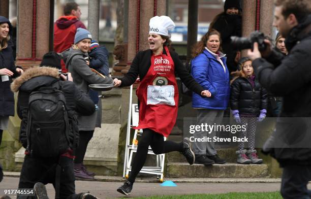 The Financial Times reporter Laua Hughes approachess the first corner in the annual Parliamentary Pancake Race in Victoria Tower Gardens on Shrove...