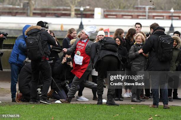 The Daily Telegraph's Political Editor Chris Hope approaches the first corner in the annual Parliamentary Pancake Race in Victoria Tower Gardens on...