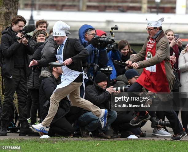 The BBC's Diplomatic correspondent James Landale and Matt Warman MP approach the first corner in the annual Parliamentary Pancake Race in Victoria...