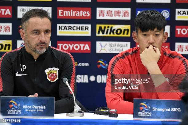 Head coach Vitor Pereira and player Yan Junling of Shanghai SIPG attend a press conference after the 2018 AFC Champions League Group F match between...