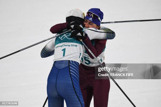 Sweden's Stina Nilsson is congratulated by Russia's Yulia Belorukova after crossing the finish line to win gold in the women's cross-country...