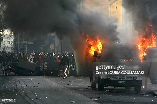 Protestors stage barricades by a burning bank armed truck car near the law school in Athens on December 18, 2008. Greece has experienced two weeks of...