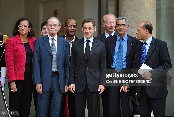 France's President Nicolas Sarkozy accompanies local executive president of Martinique and French Guyana at the end of a meeting on October 7, 2009...