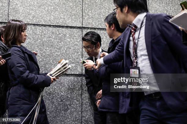 Yusuke Otsuka, chief operating officer and co-founder of cryptocurrency exchange Coincheck Inc., center, bows as he leaves after speaking in front of...