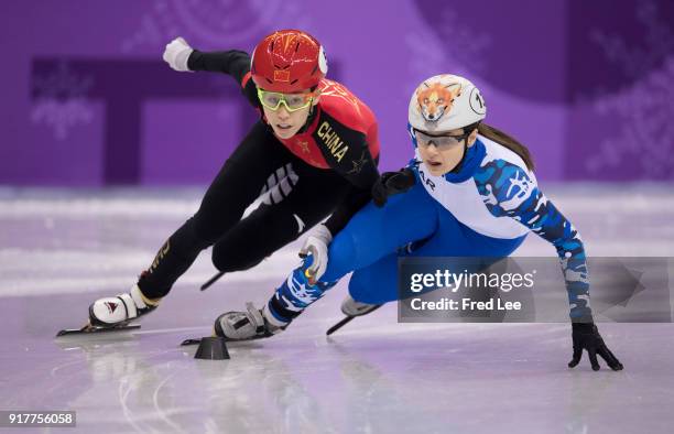 Kexin Fan of China and Sofia Prosvirnova of Olympic Athlete from Russia compete during the Ladies' 500m Short Track Speed Skating quarterfinal on day...