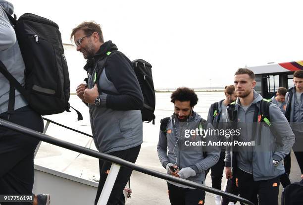 Jurgen Klopp manager of Liverpool with Mohamed Salah and Jordan Henderson of Liverpool board the plane for their trip to Porto at Liverpool John...