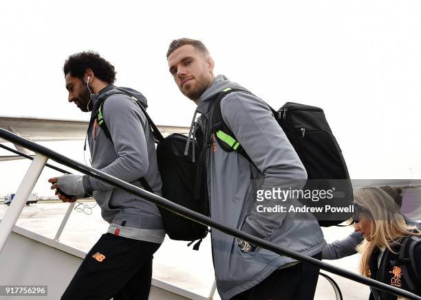 Mohamed Salah and Jordan Henderson of Liverpool board the plane for their trip to Porto at Liverpool John Lennon Airport on February 13, 2018 in...