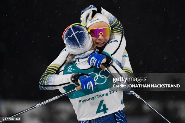 Sweden's Stina Nilsson is congratulated by Sweden's Hanna Falk after winning gold in the women's cross-country individual sprint classic final at the...