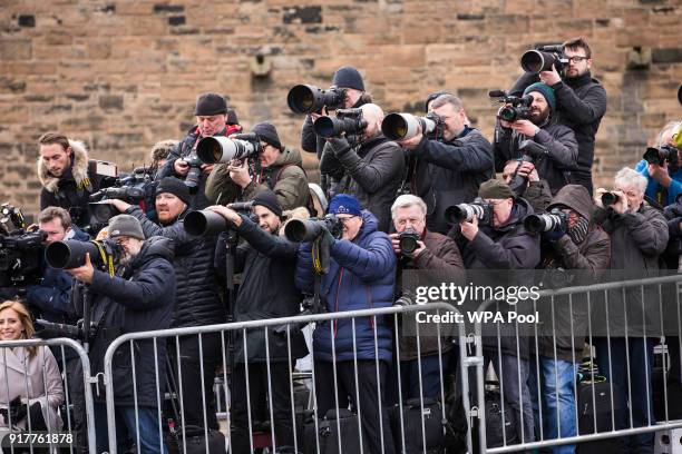 Members of the press take photos of Prince Harry and Meghan Markle during a walkabout on the esplanade at Edinburgh Castle on February 13, 2018 in...