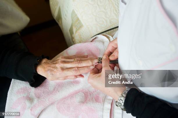 Aubigny-en-Artois . . Nursing home for dependent elderly persons . Manicure. Woman, resident, having her nails cut.