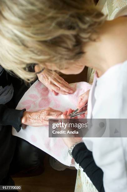 Aubigny-en-Artois . . Nursing home for dependent elderly persons . Manicure. Woman, resident, having her nails cut.